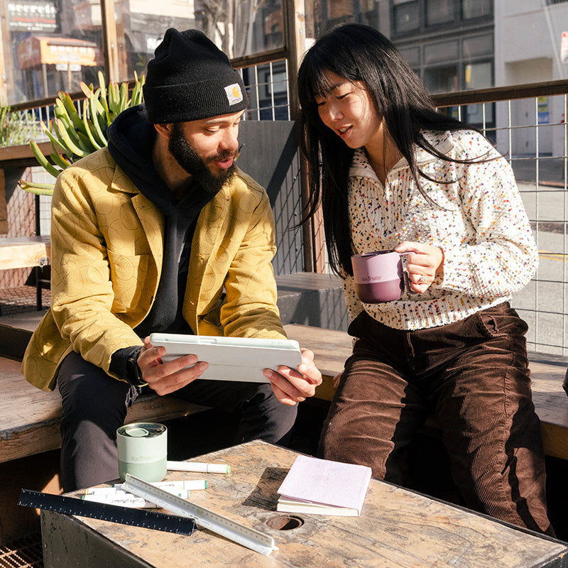 12oz-rise-mug-t6 12oz_rise_coffee_mug_dusty_orchid_couple_city_patio_square.jpg