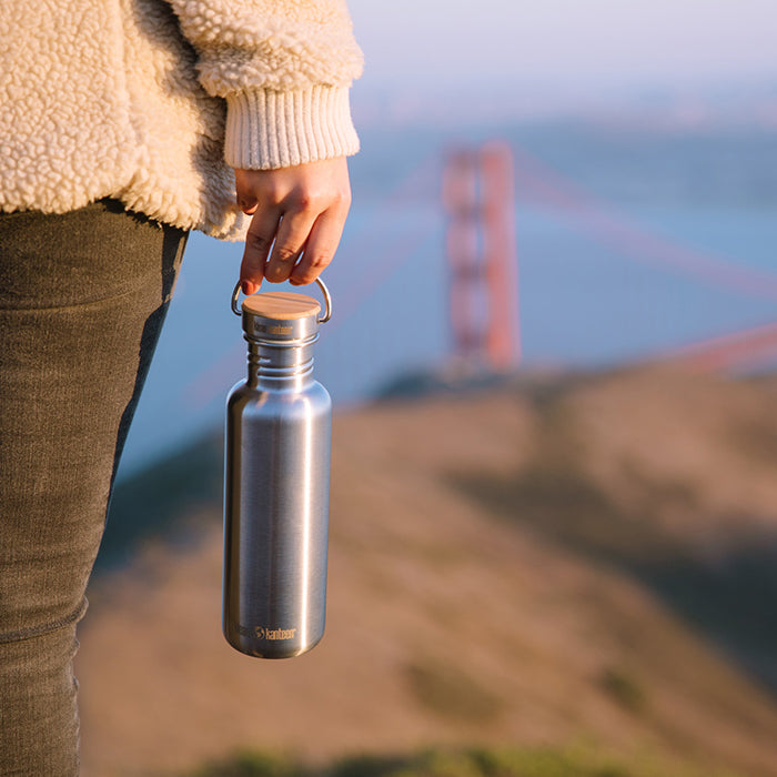 27oz-reflect-with-bamboo-cap-t0 K27SSLRF-BS-BAMBOO_reflect_bottle_bridge_lifestyle.jpg